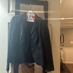 Navy blue blazer with a button-up front and a single-breasted style